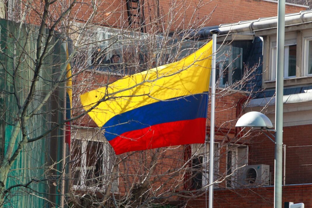 Urna electoral con bandera de Colombia y Argentina de fondo